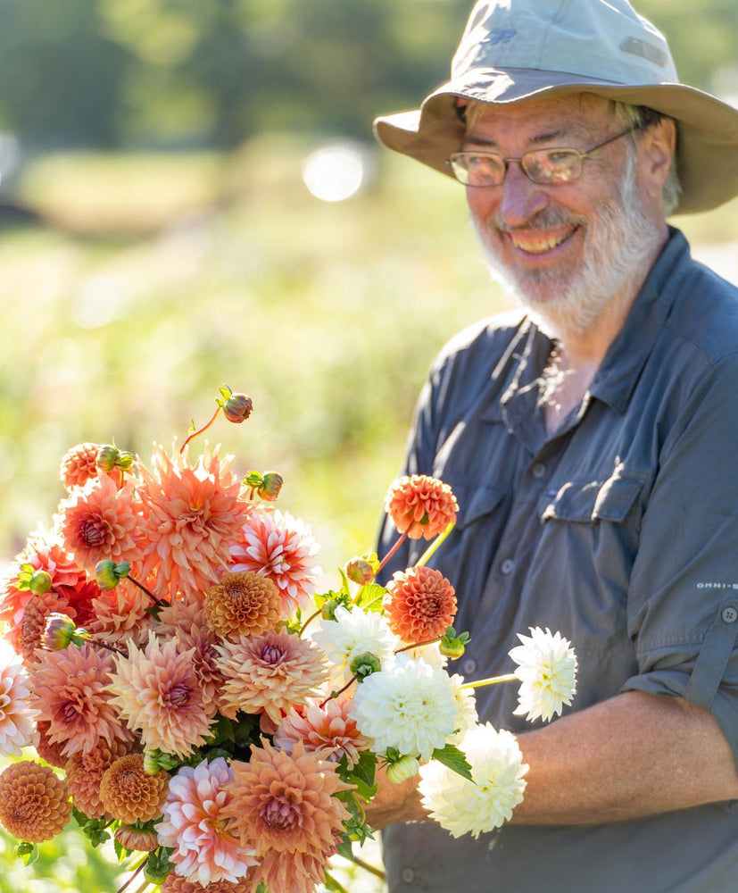 emily's father winslow holding dahlias at grounded flower farm