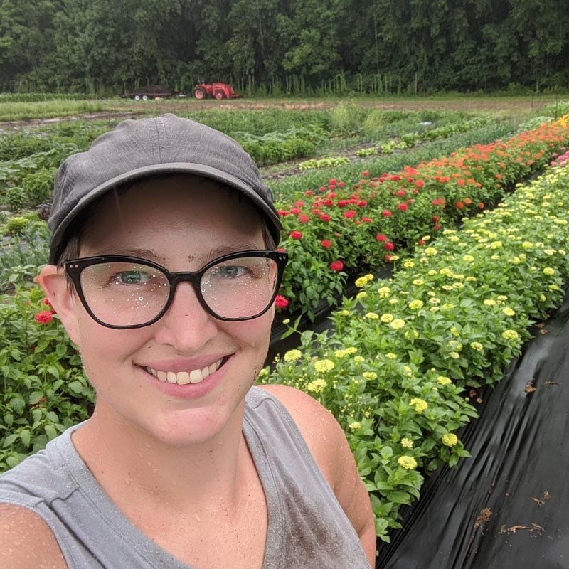 
                  
                    emily of grounded flower farm with zinnias
                  
                